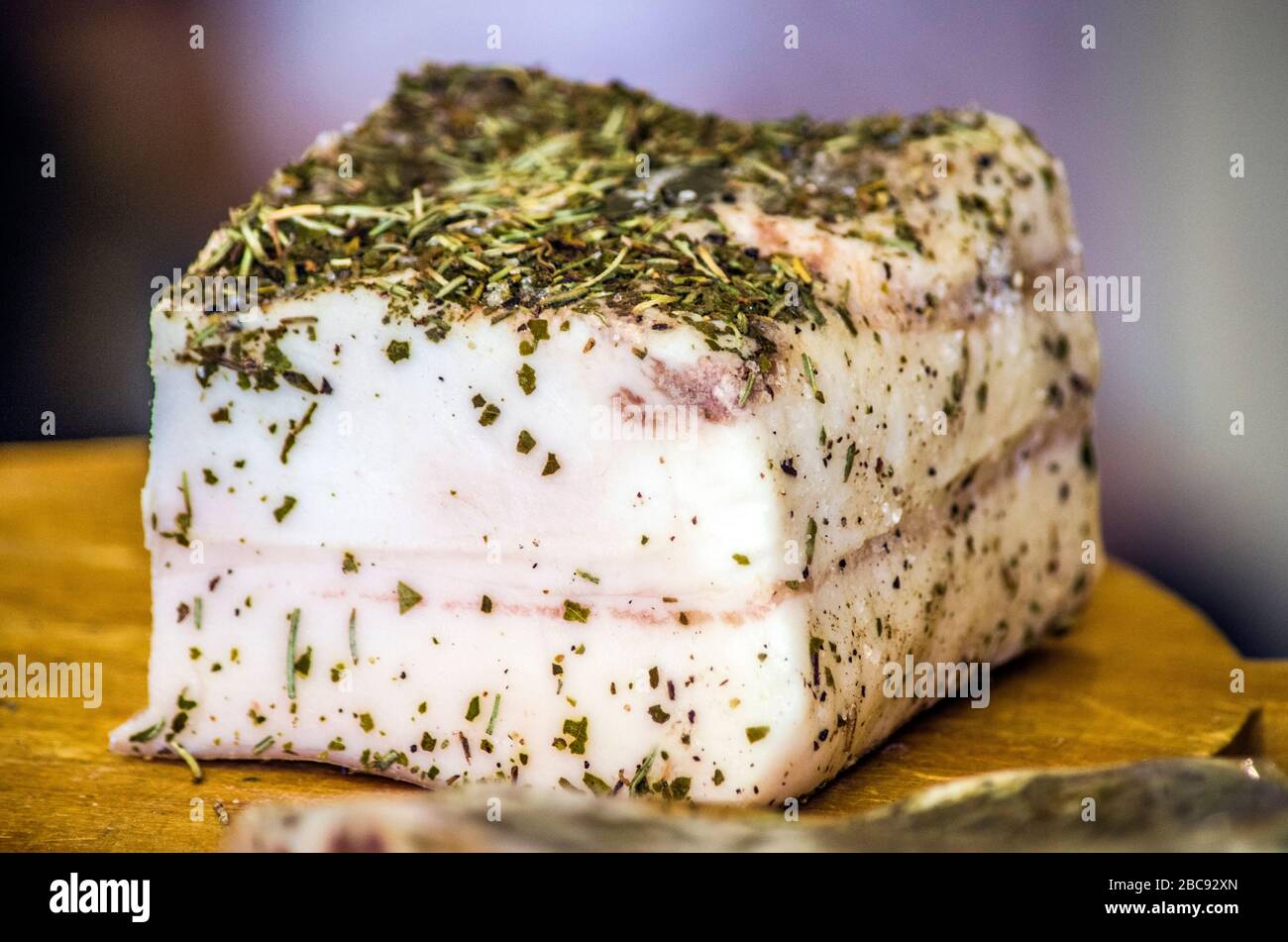 seasoned lard in a cave with aromatic herbs ready to flavor your delicious dishes Stock Photo