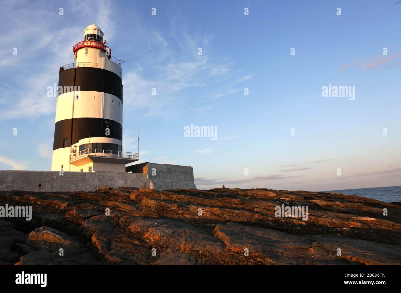 Hook Head Lighthouse is situated at the tip of the Hook Peninsula in County Wexford, in Ireland. It is one of the oldest lighthouses in the world. Stock Photo
