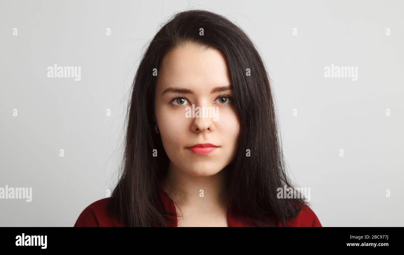 Head and shoulreds woman headshot in red over white background. Stock Photo