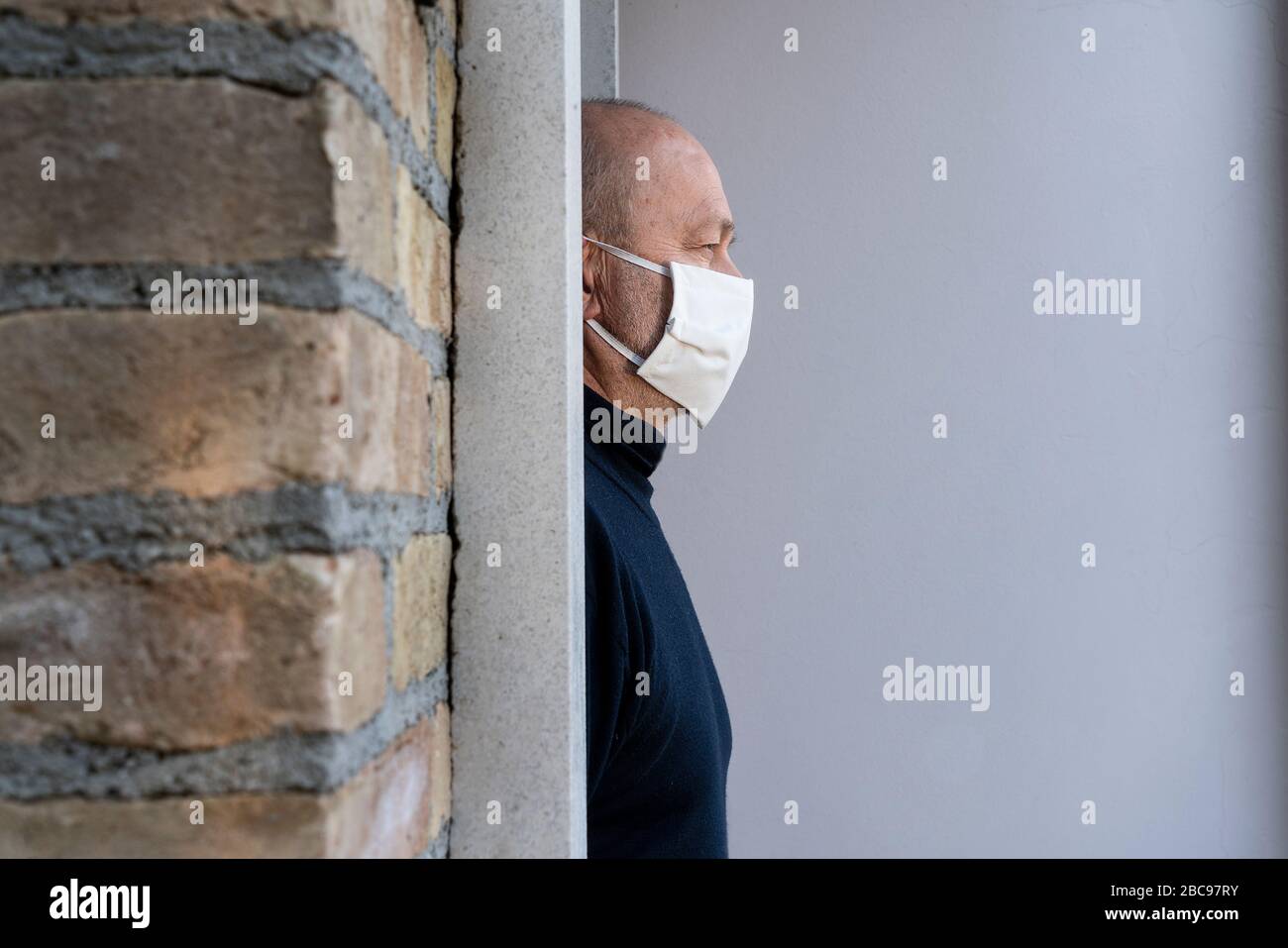 a man who leaves home with a protective mask over his mouth during the coronavirus pandemic Stock Photo