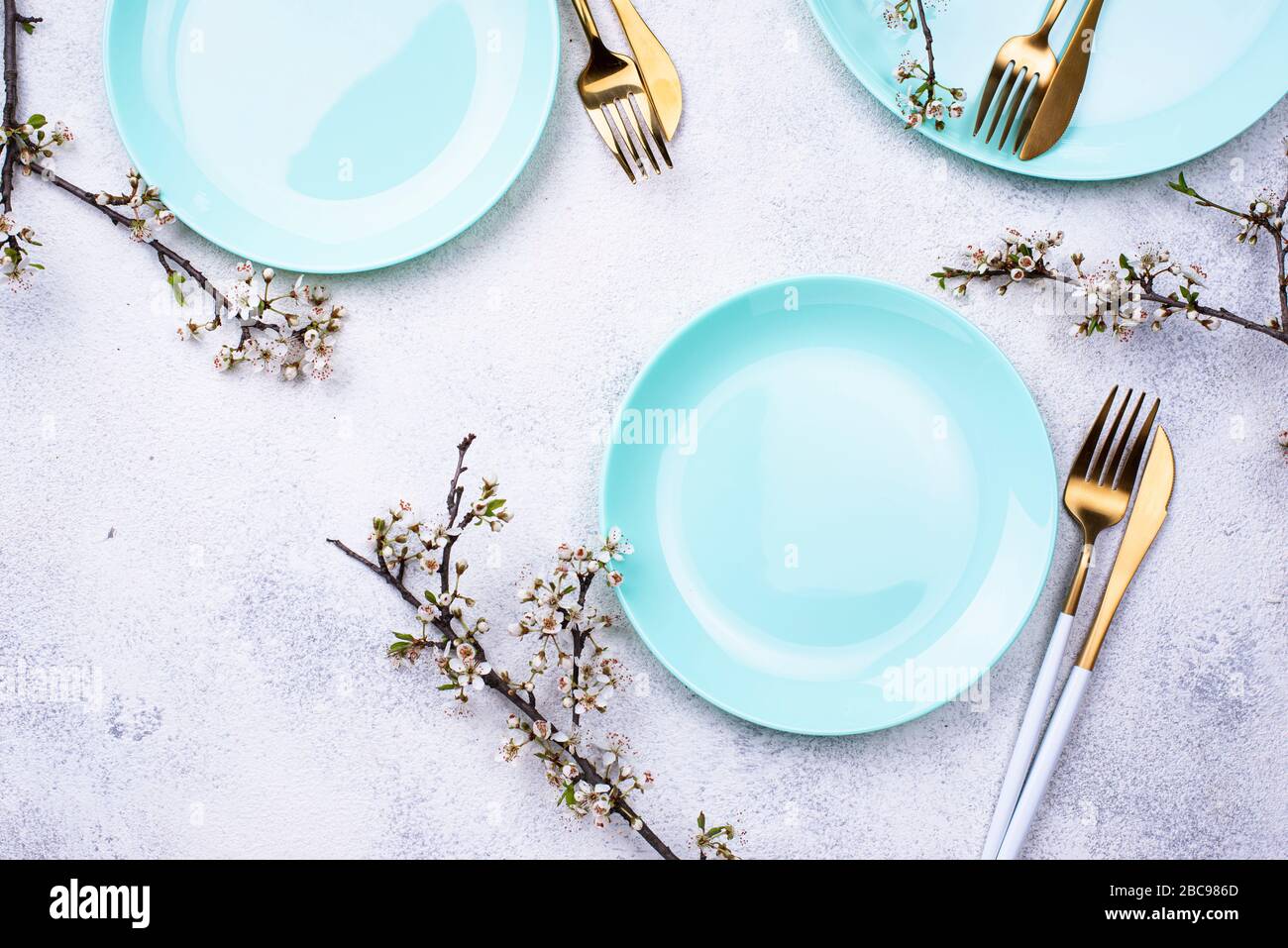 Spring table setting with blooming branch Stock Photo