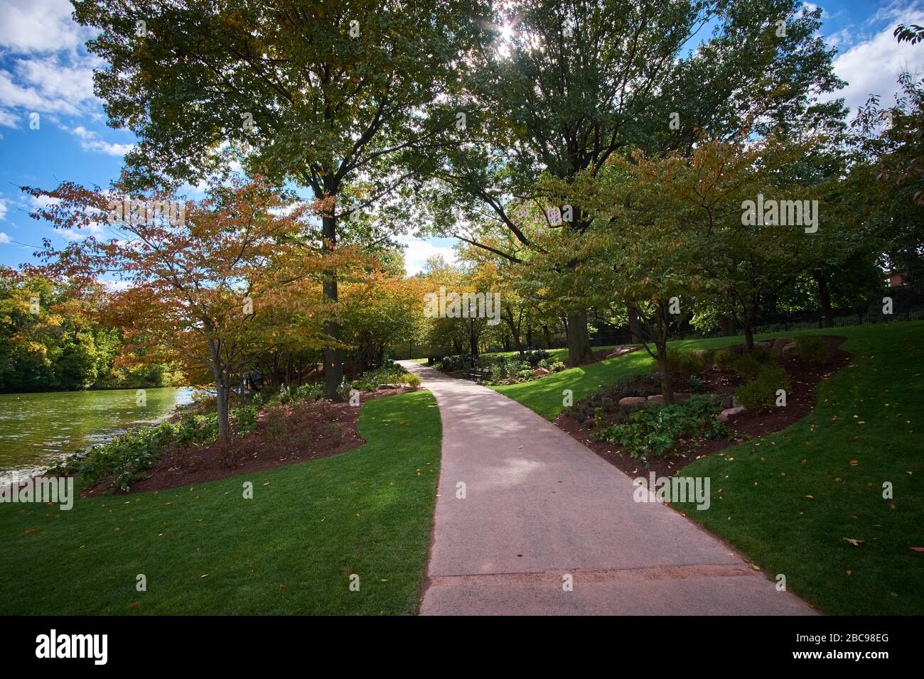 Newark, New Jersey, USA - 10/24/2018: Branch Brook Park on a sunny day showing concrete walking path. Stock Photo