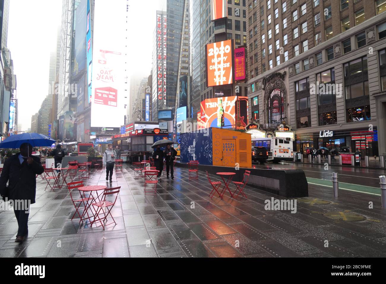 People walking with umbrellas, Times Square, New York City Stock Photo
