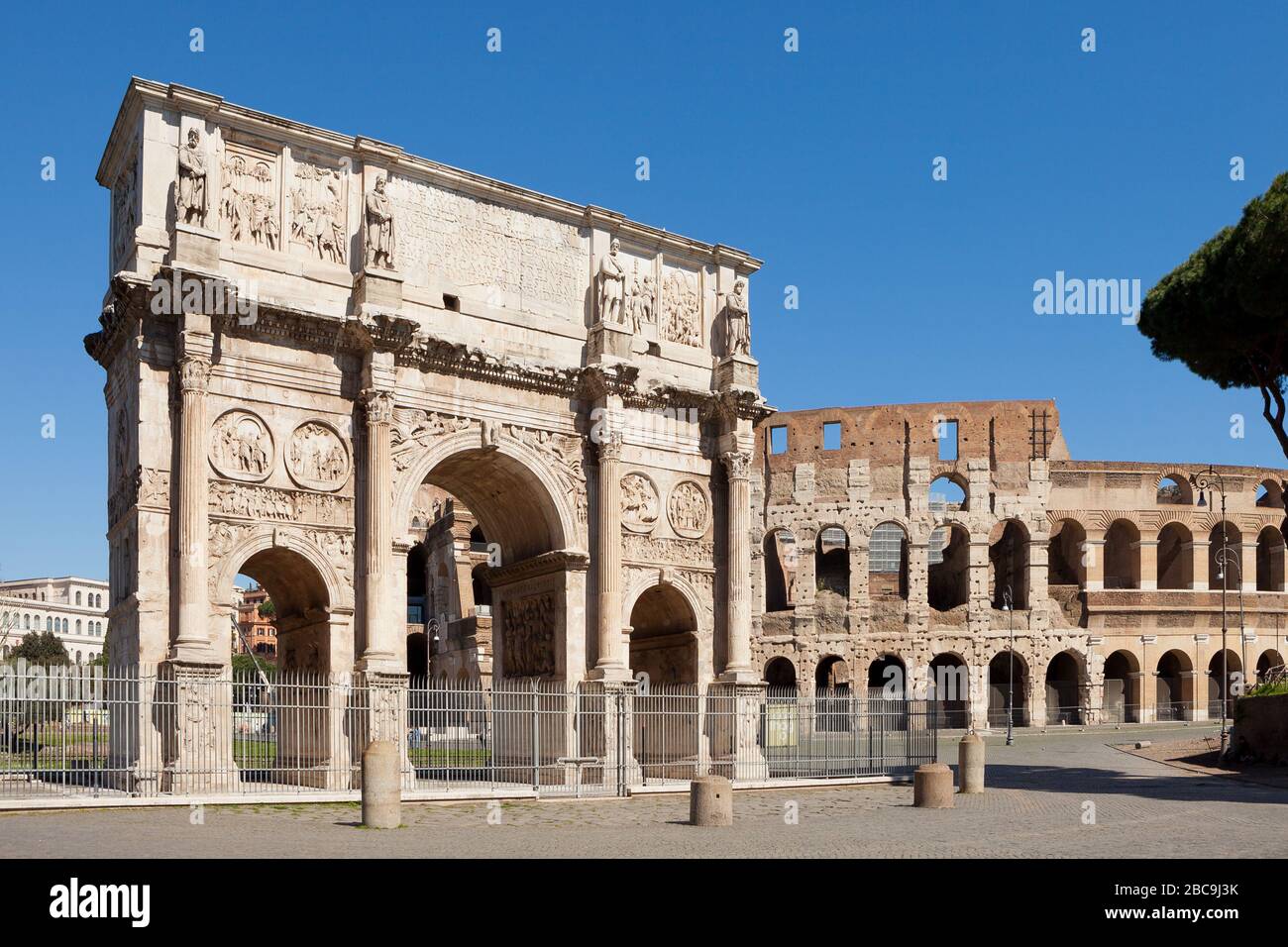 The Arch of Constantine (Arco di Costantino).  Triumphal arch and Colosseum on background. Rome, Italy Stock Photo