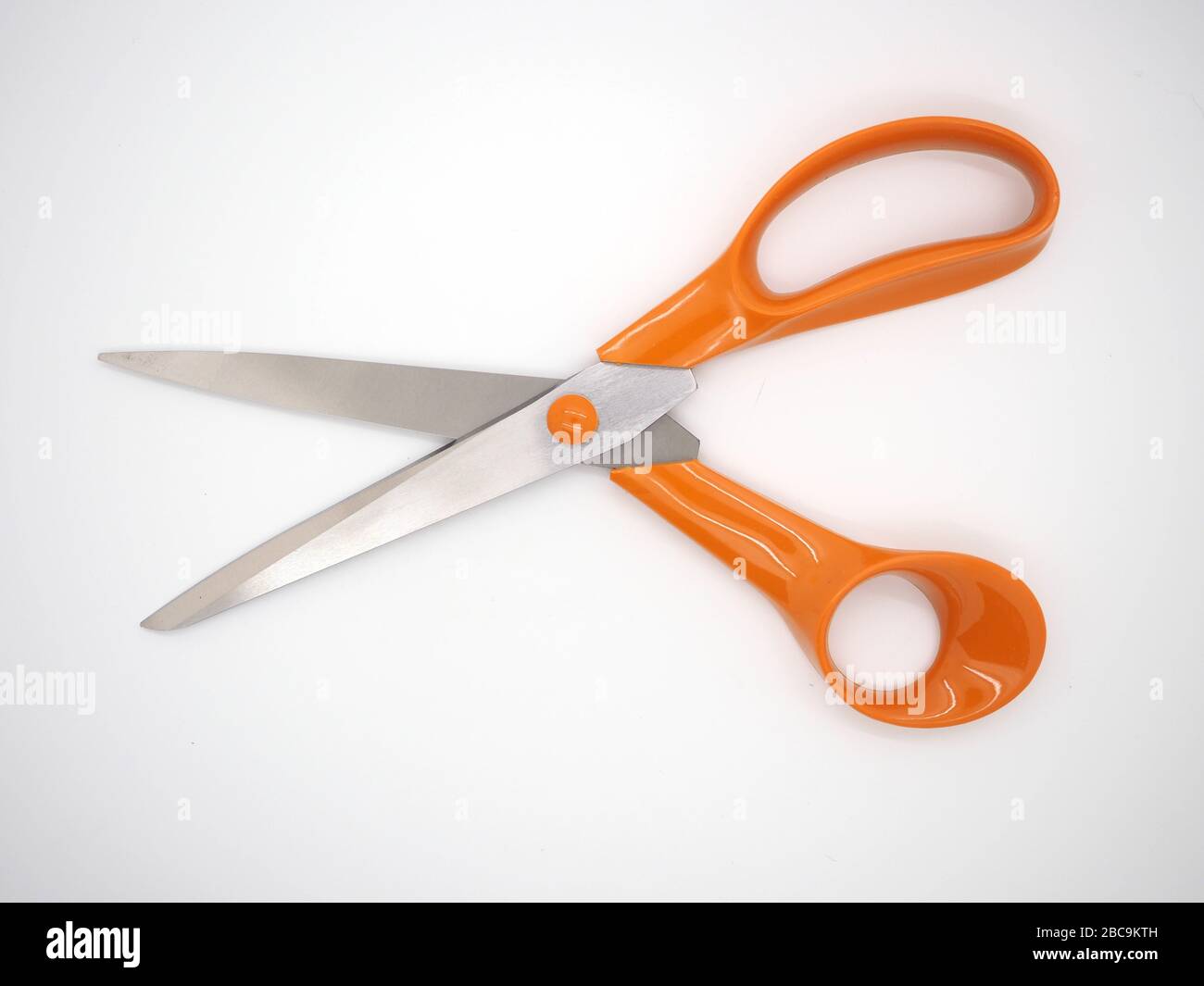 Close Up Of An Isolated Pair Of Scissors With Orange Handles, London