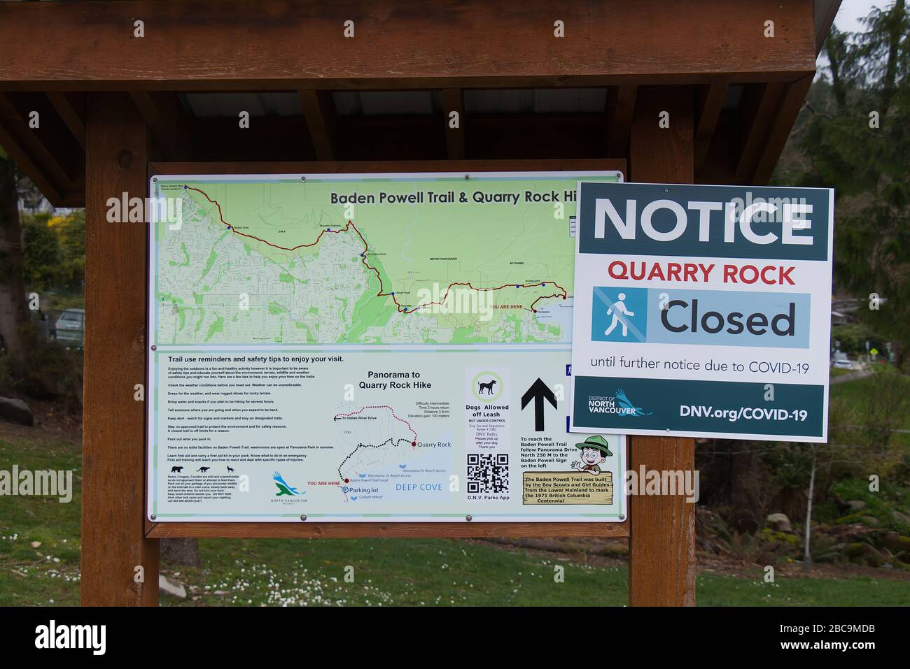 Deep Cove, North Vancouver, Canada - April 1,2020: View of warning sign 'Quarry Rock Closed until further notice due to COVID-19' Stock Photo