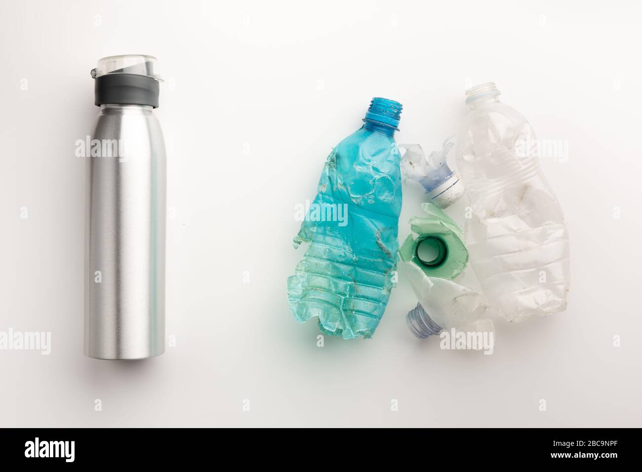 Plastic bottles compared with aluminium one isolated on white