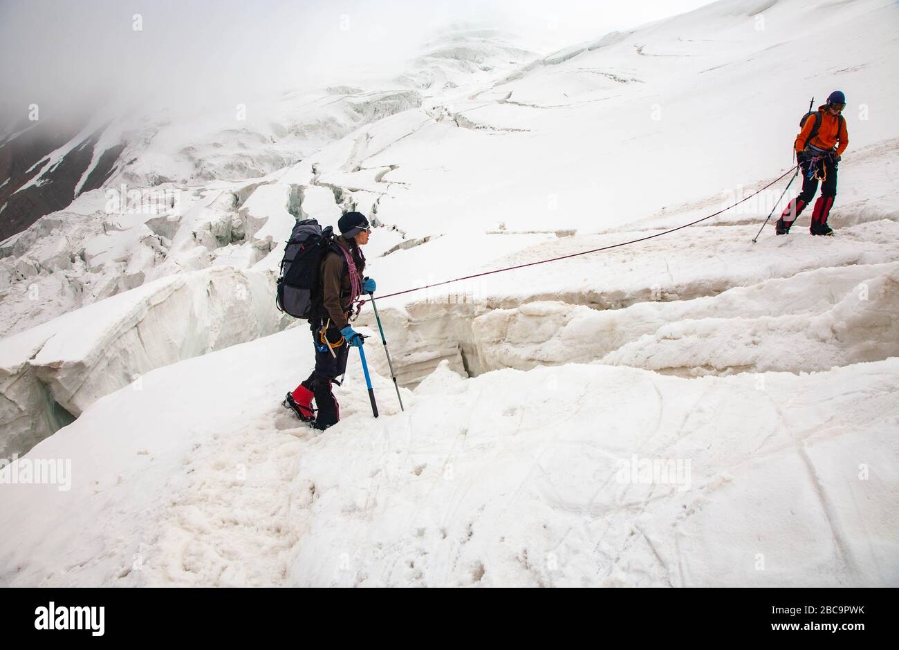 The Trans-Alay Range. Pamir Mountain System. Two climbers with belay ...