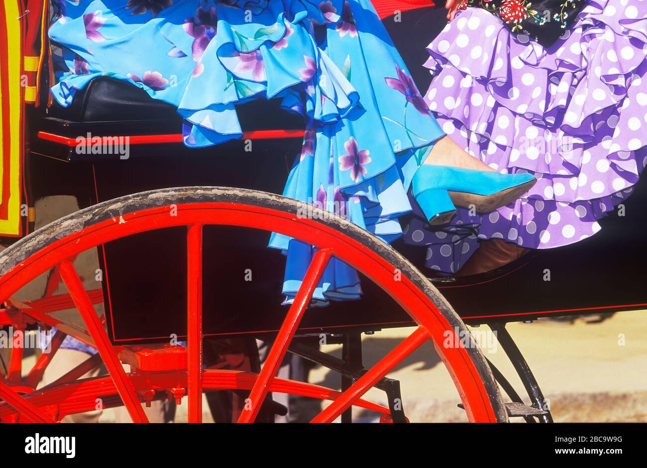 Details of festival goer's dresses and traditional chariot, Seville, Andalucia, Spain Stock Photo