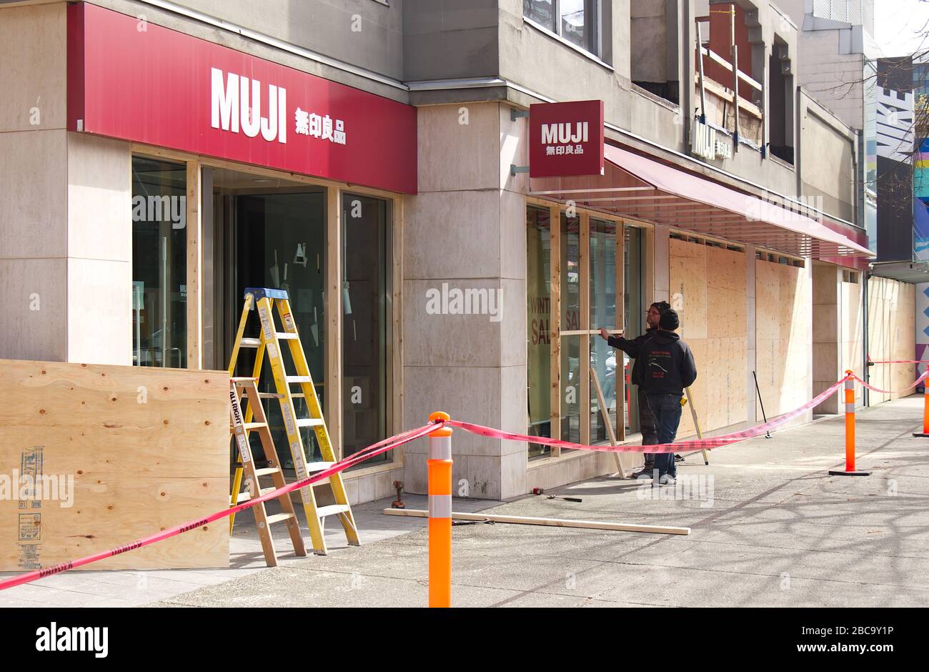 Vancouver Canada Apr 2 2020 Workers Is Boarding Up The Storefront vancouver-canada-apr-2-2020-workers-is-boarding-up-the-storefront