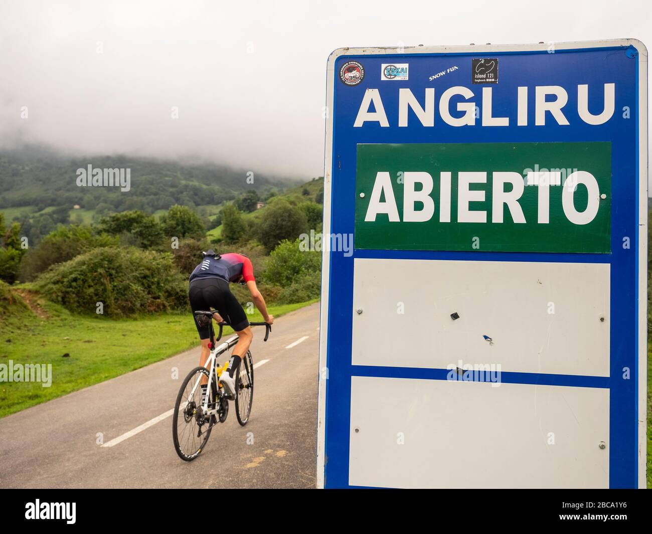 Road cycling in Asturias, northern Spain. Road cyclists on mountain road to the summit of Angliru, a mythical mountain arrival of the Vuelta a España Stock Photo