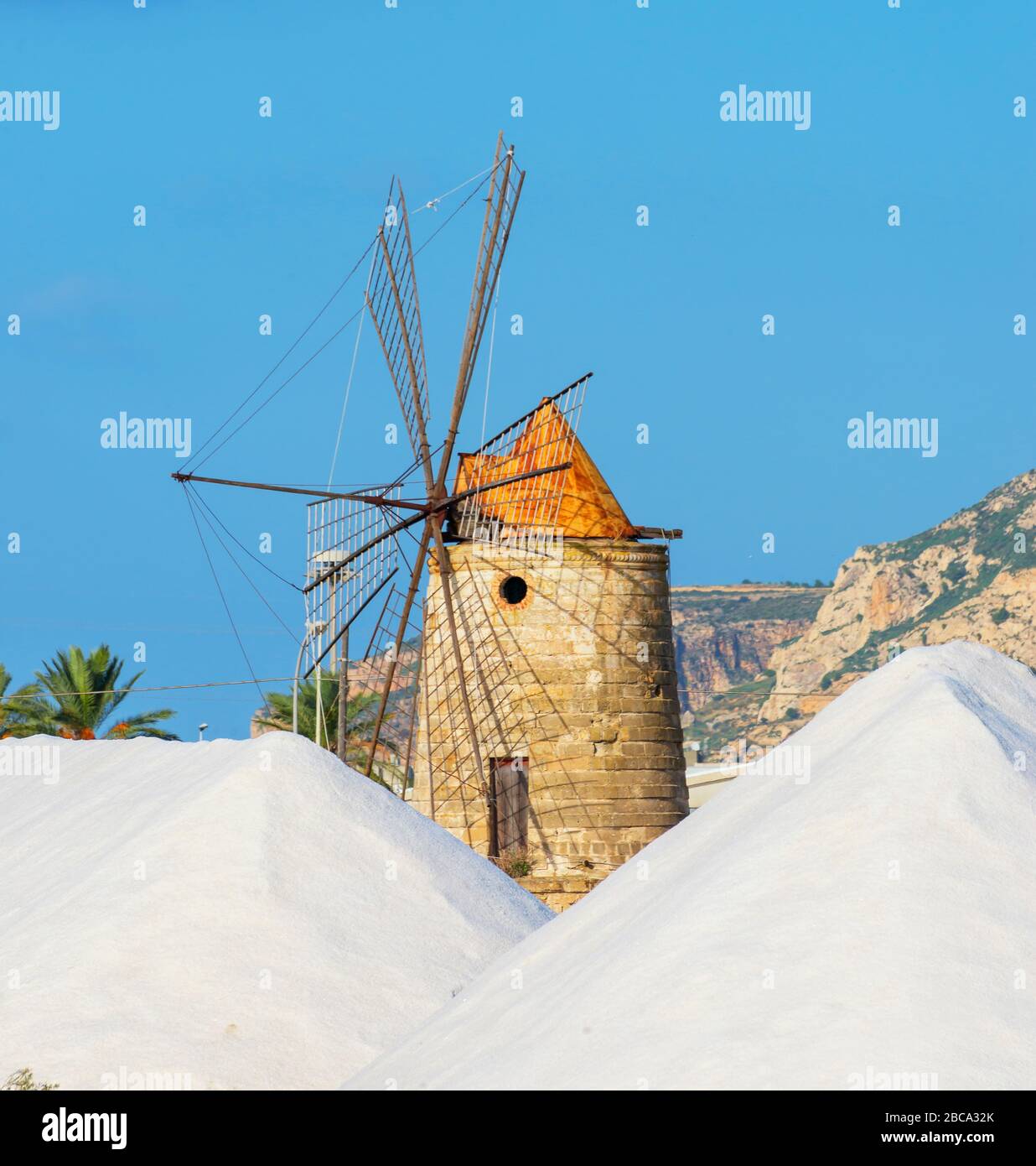 Salt stacks near old wndmill, Trapani, Sicily, Italy. Stock Photo