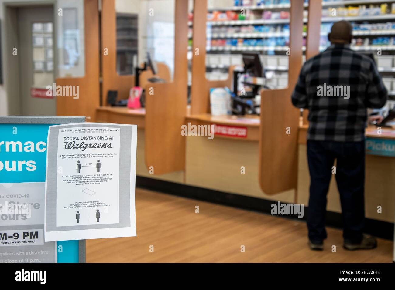 Little Canada; Minnesota. A sign in a Walgreen's drugstore to respect  social distancing while using the pharmacy with a customer picking up an  order Stock Photo - Alamy