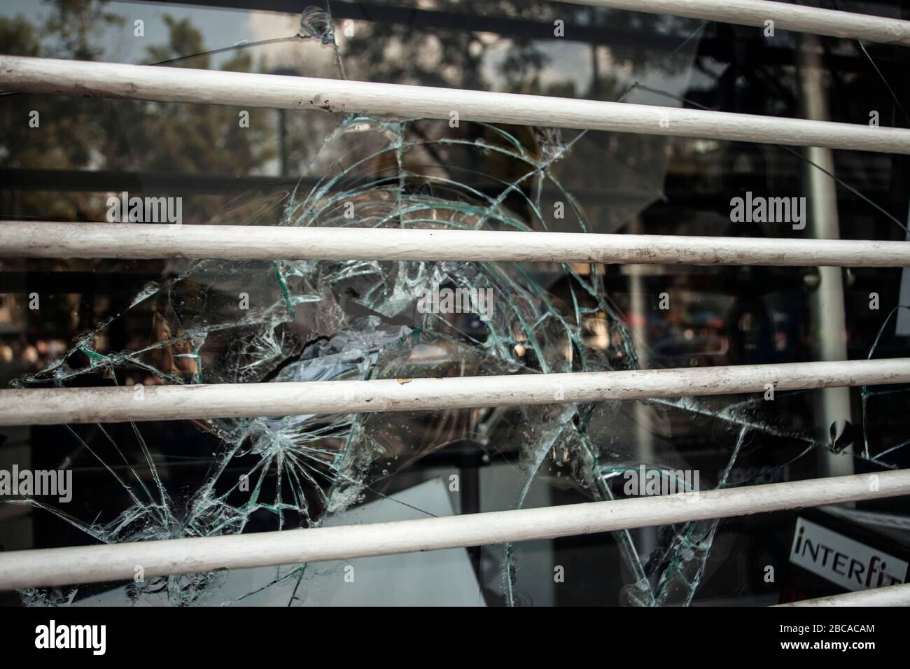 Window broken during looting Stock Photo