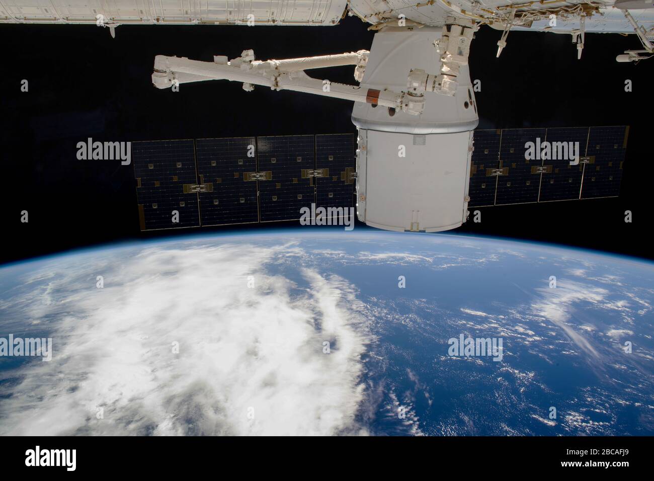 ISS - 09 Mar 2020 - The SpaceX Dragon resupply ship is pictured attached to the International Space Station's Harmony module as both spacecraft were s Stock Photo