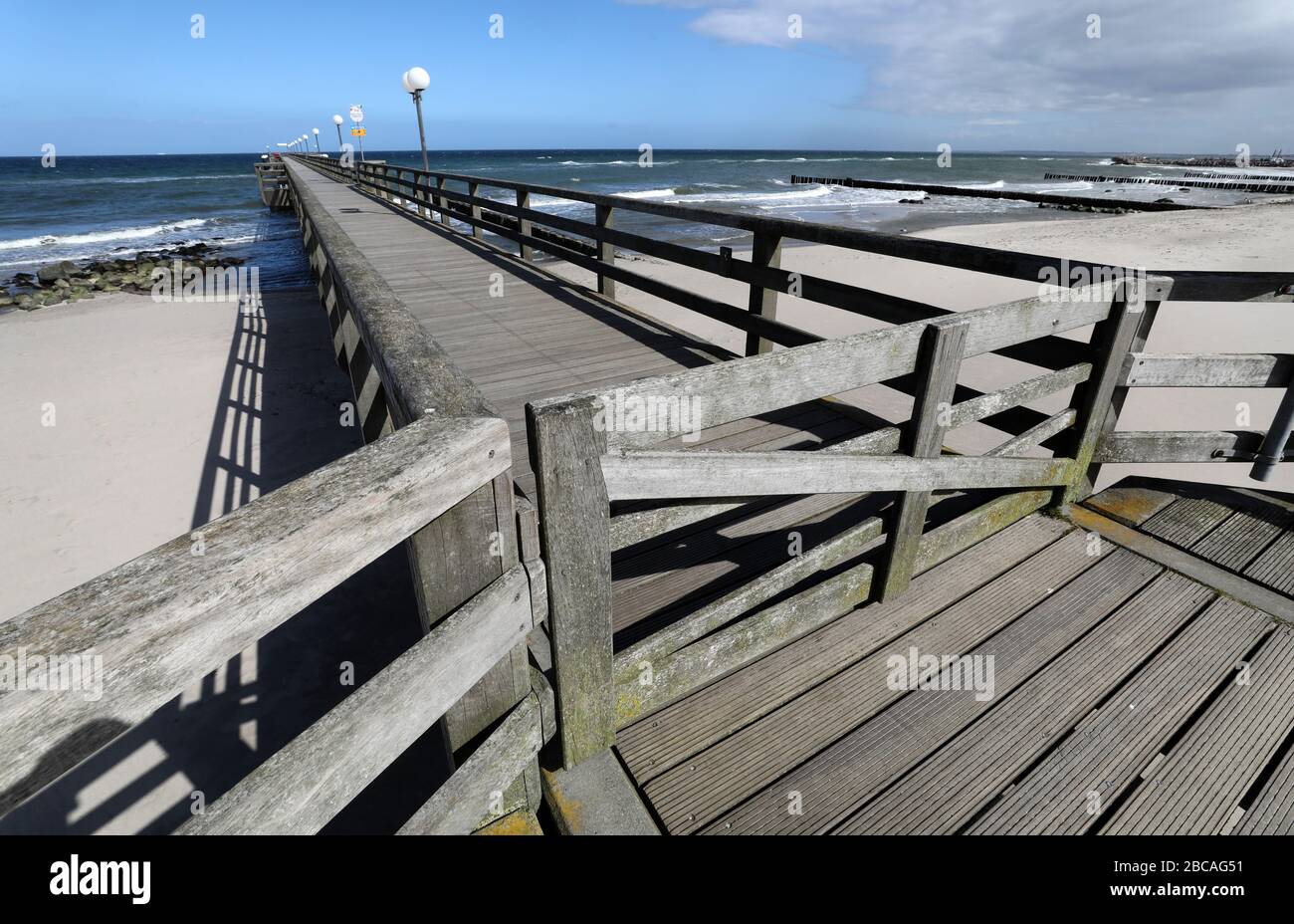 03 April 2020, Mecklenburg-Western Pomerania, Kühlungsborn: The pier is closed, the east beach deserted. Due to the severe restrictions in public life, the traditional start of the season at the Baltic Sea at Easter will be cancelled this year. Photo: Bernd Wüstneck/dpa-Zentralbild/dpa Stock Photo