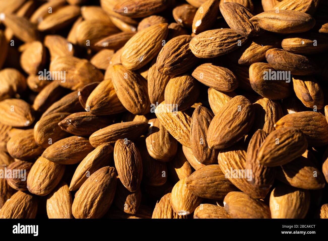 Almonds macro. Almonds background. Almond nuts. Organic texture of almonds. View from above Stock Photo