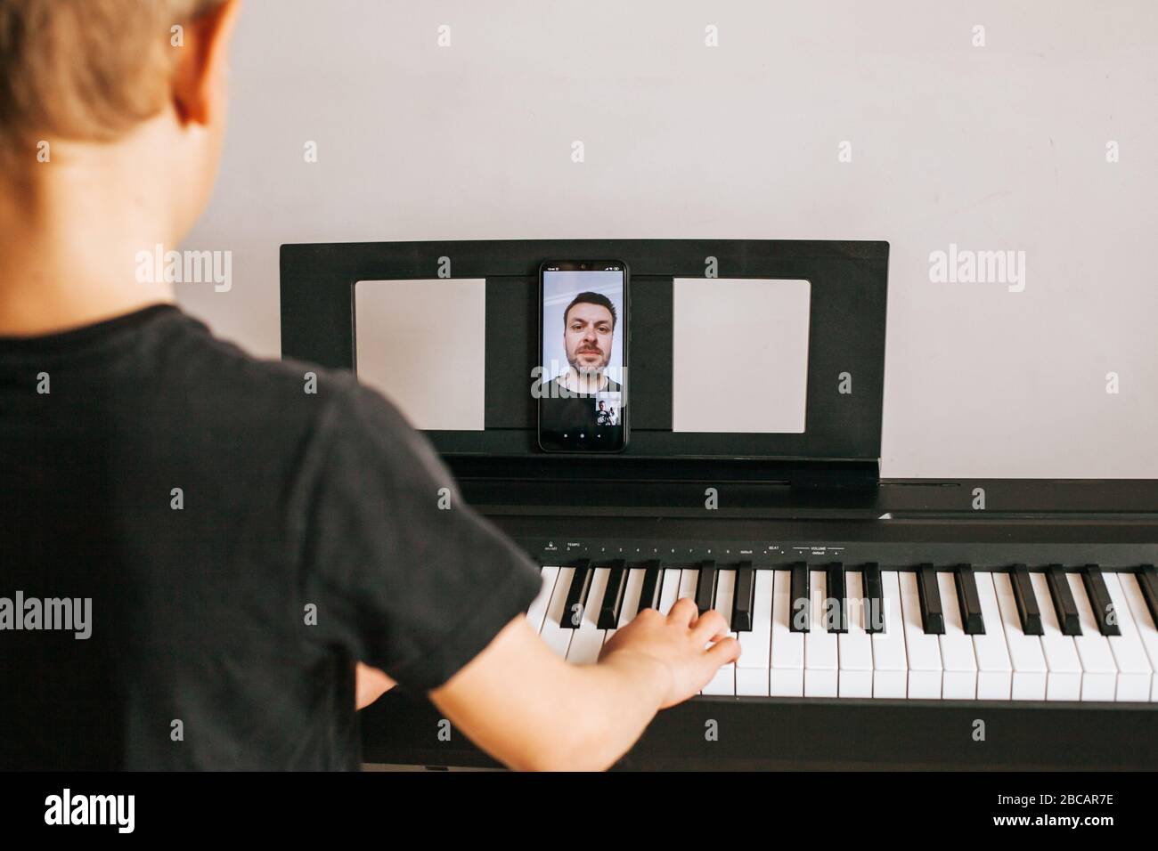 Child hands playing piano.Cllose-up piano, white and black keyboard Stock Photo