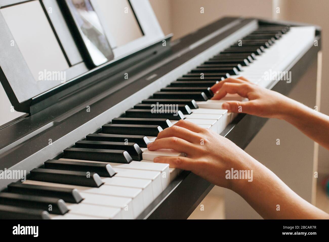 Child hands playing piano.Cllose-up piano, white and black keyboard Stock Photo