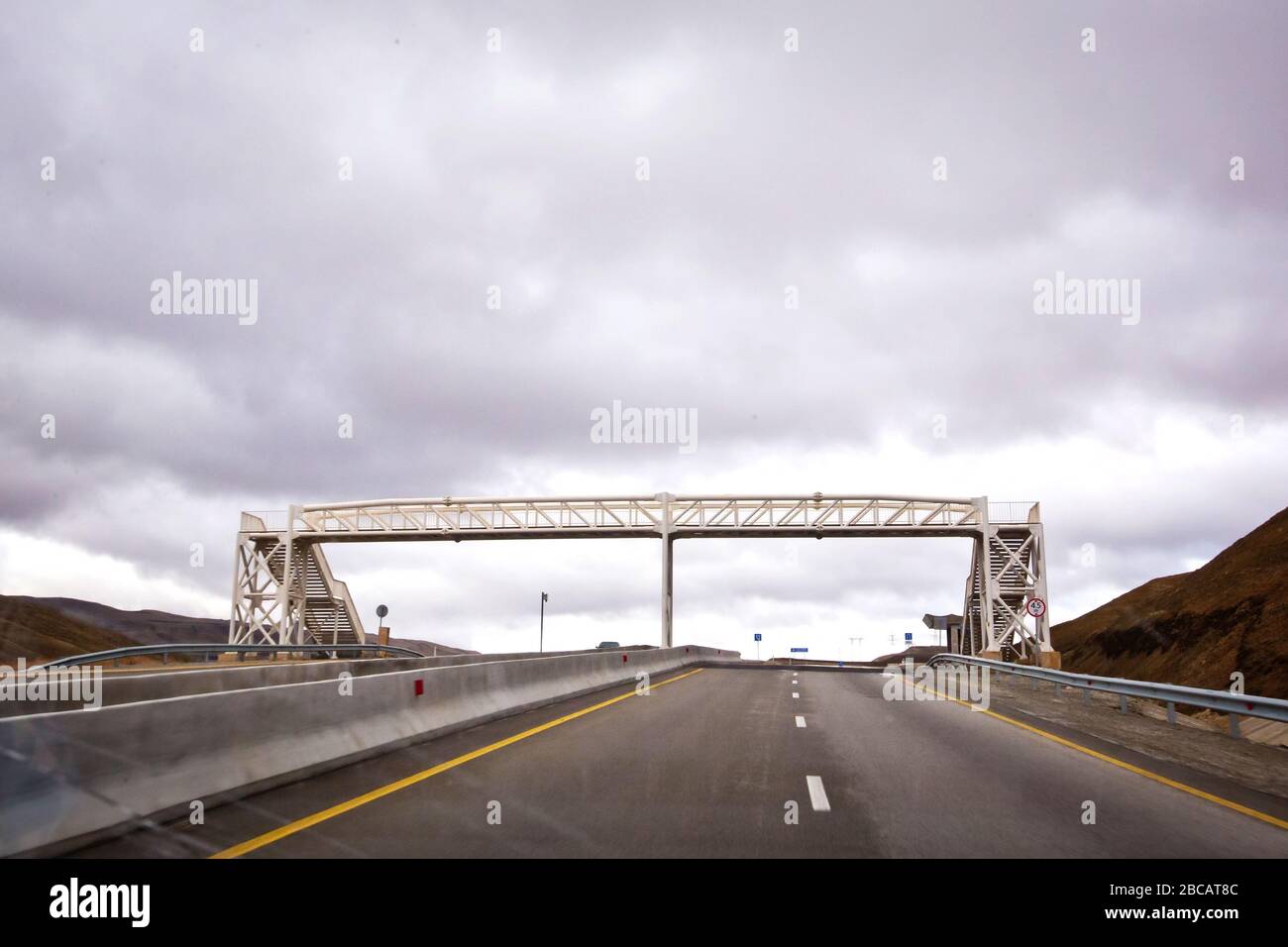 Bridges crossing people without a roof. Open road with blue clouds . The pedestrian crossing bridge . Stock Photo