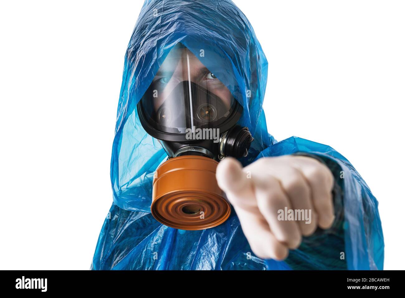 A man in a gas mask and a protective suit shows a finger at the camera, isolated on a white background. Virus attack protection concept Stock Photo