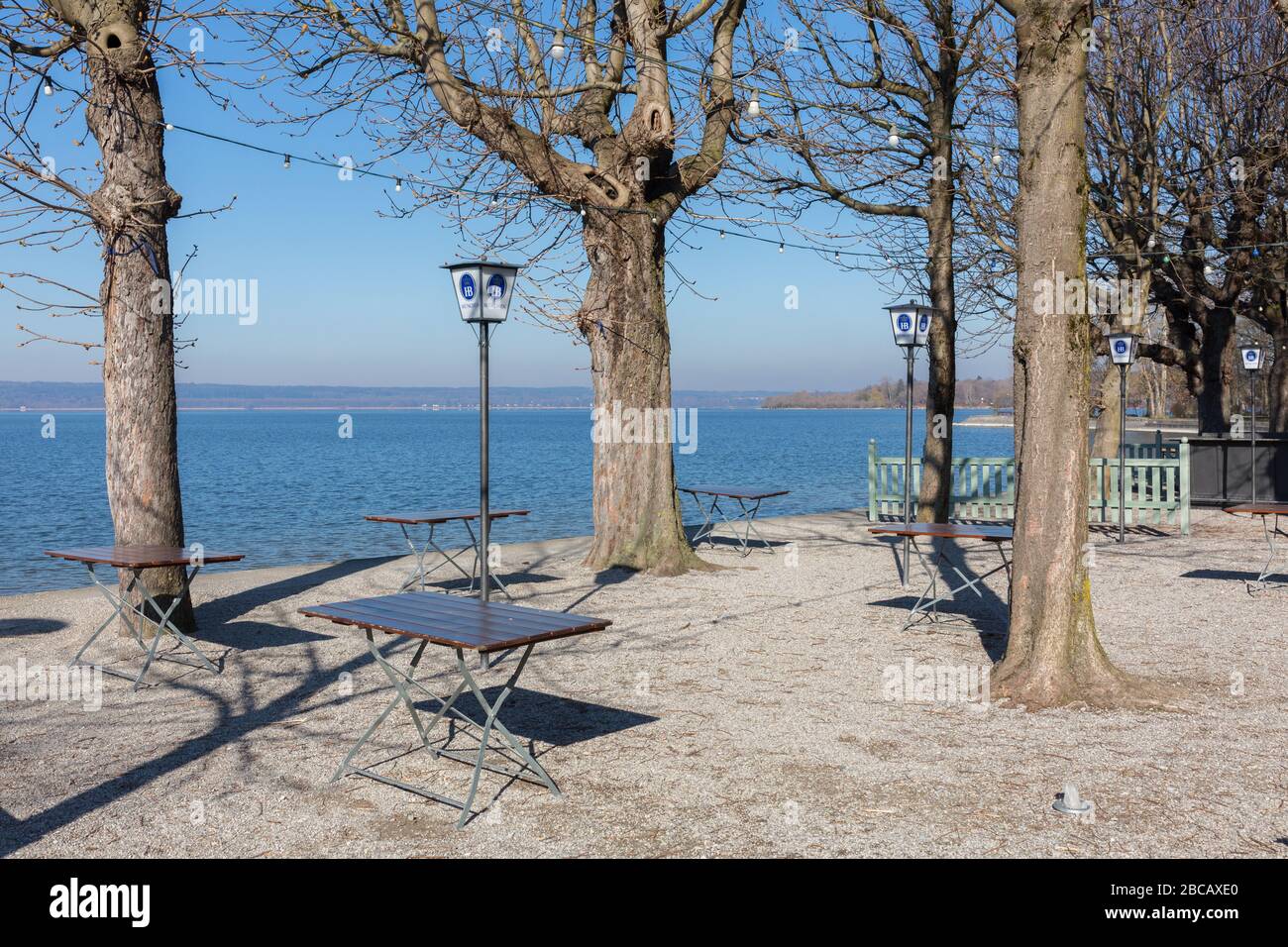 An empty beer garden at a sunny spring day. In Bavaria all restaurants are closed for visitors due to restrictions related to the Coronavirus. Stock Photo