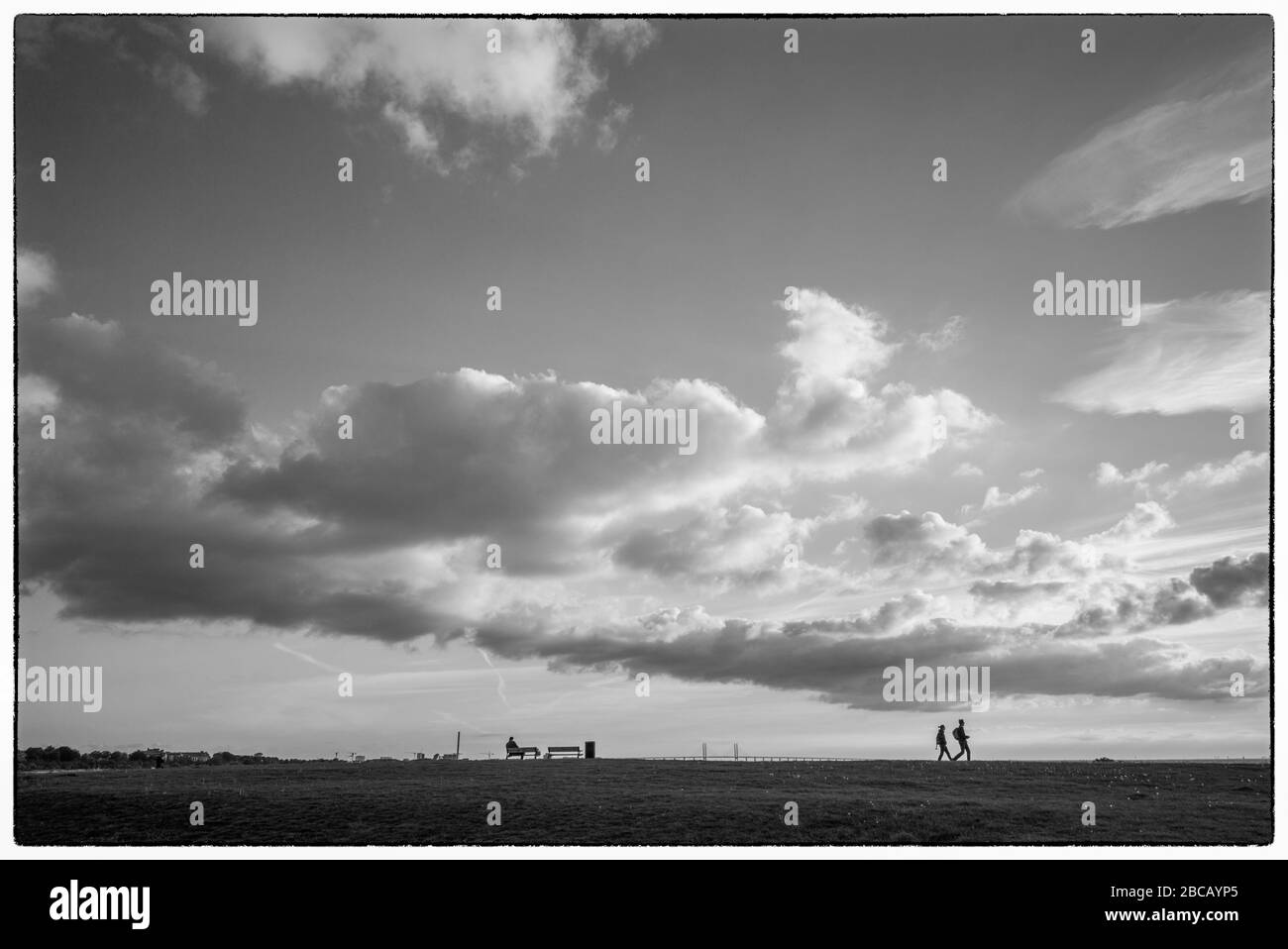 Sweden, Scania, Malmo, Riberborgs Stranden beach area, walkers at dusk, Stock Photo