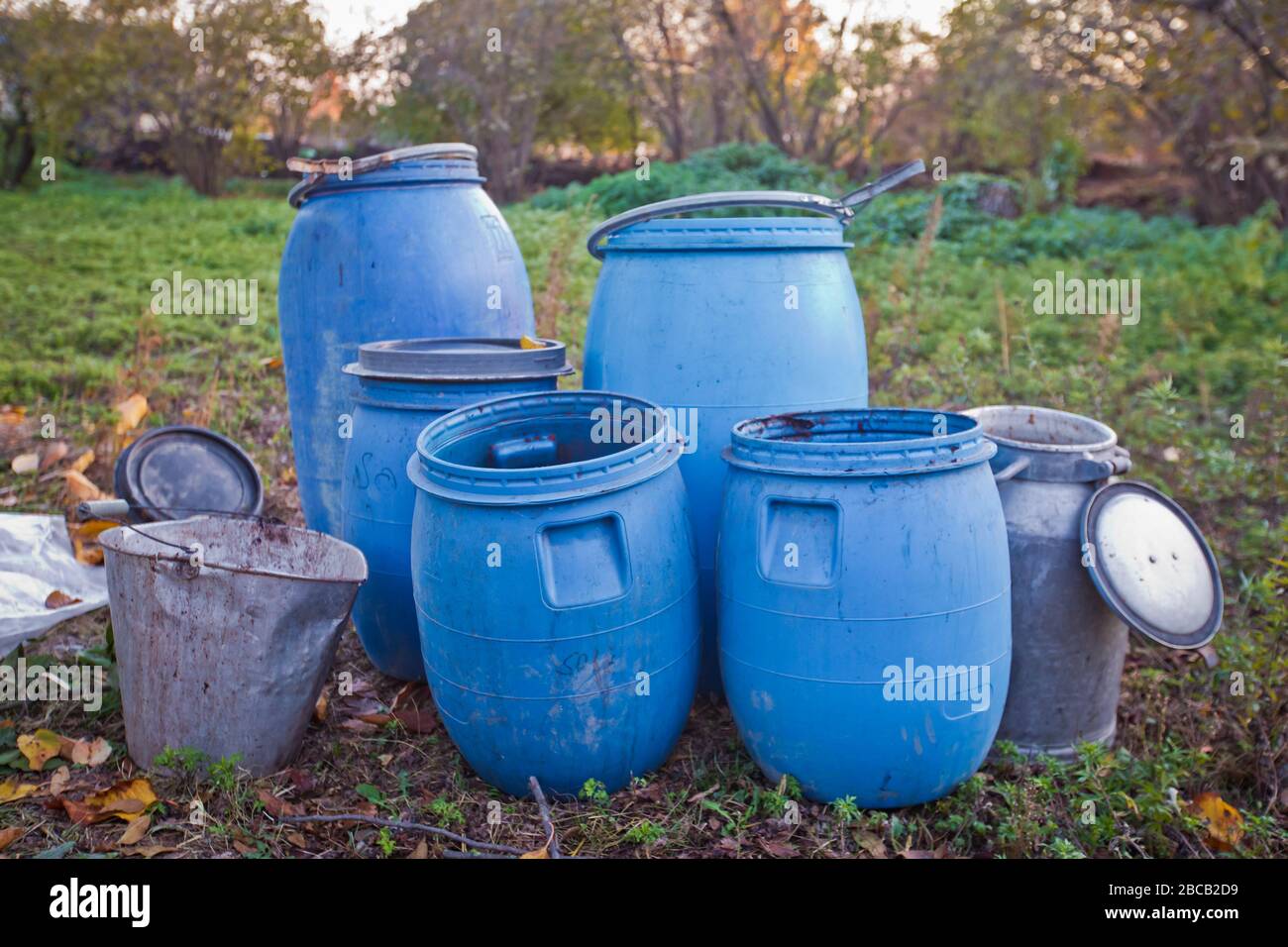 The blue plastic barrels for storage of chemicals . Stockpile of used
