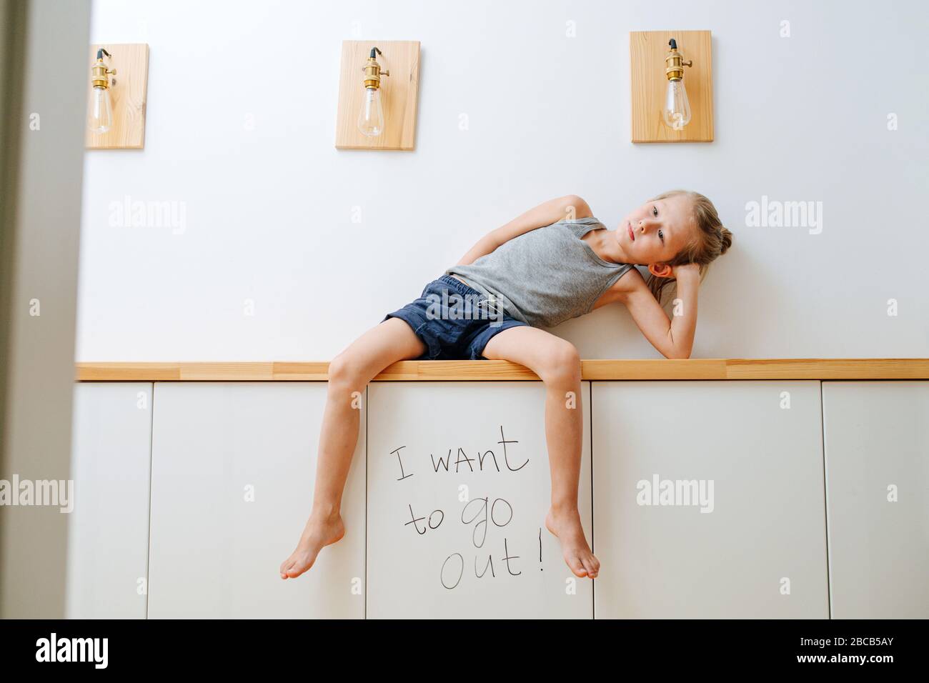 Unhappy little boy's self isolation going very slow Stock Photo