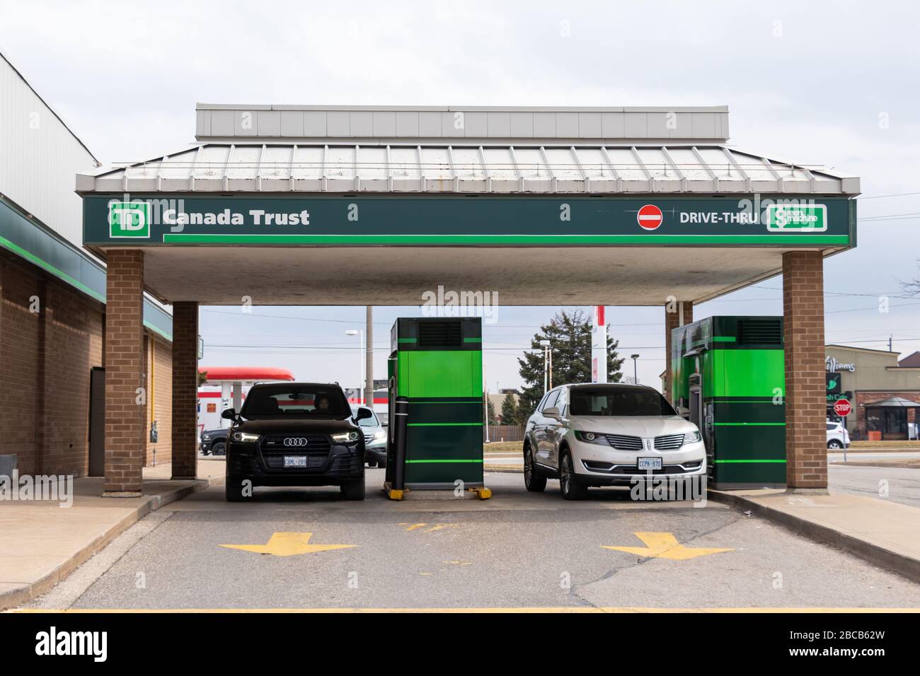 Cars stopped at a drive-thru ATM at TD Canada Trust branch in a city. Stock Photo