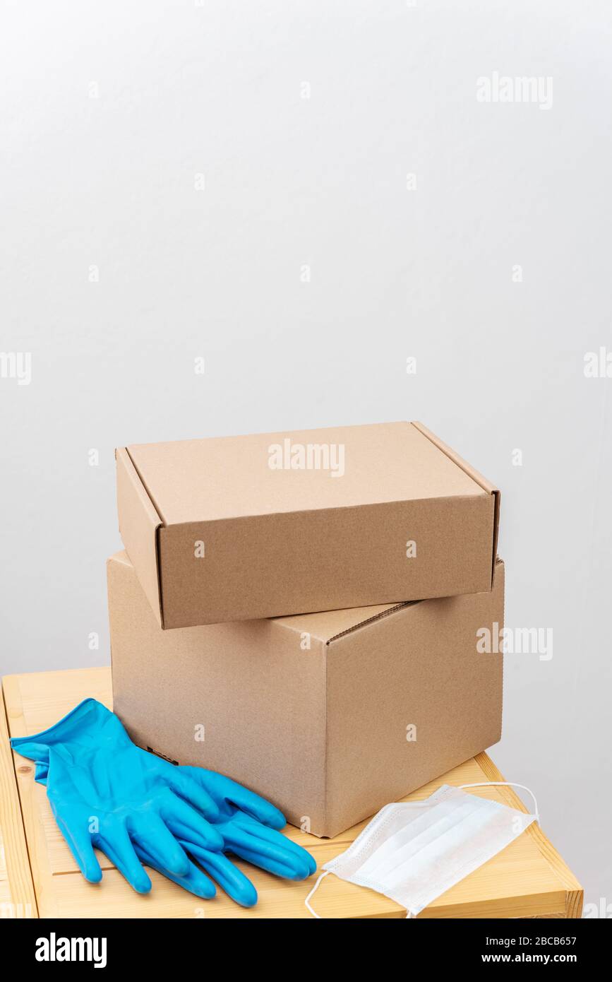 Contact less delivery concept, safe shipment, courier with carboard box ...