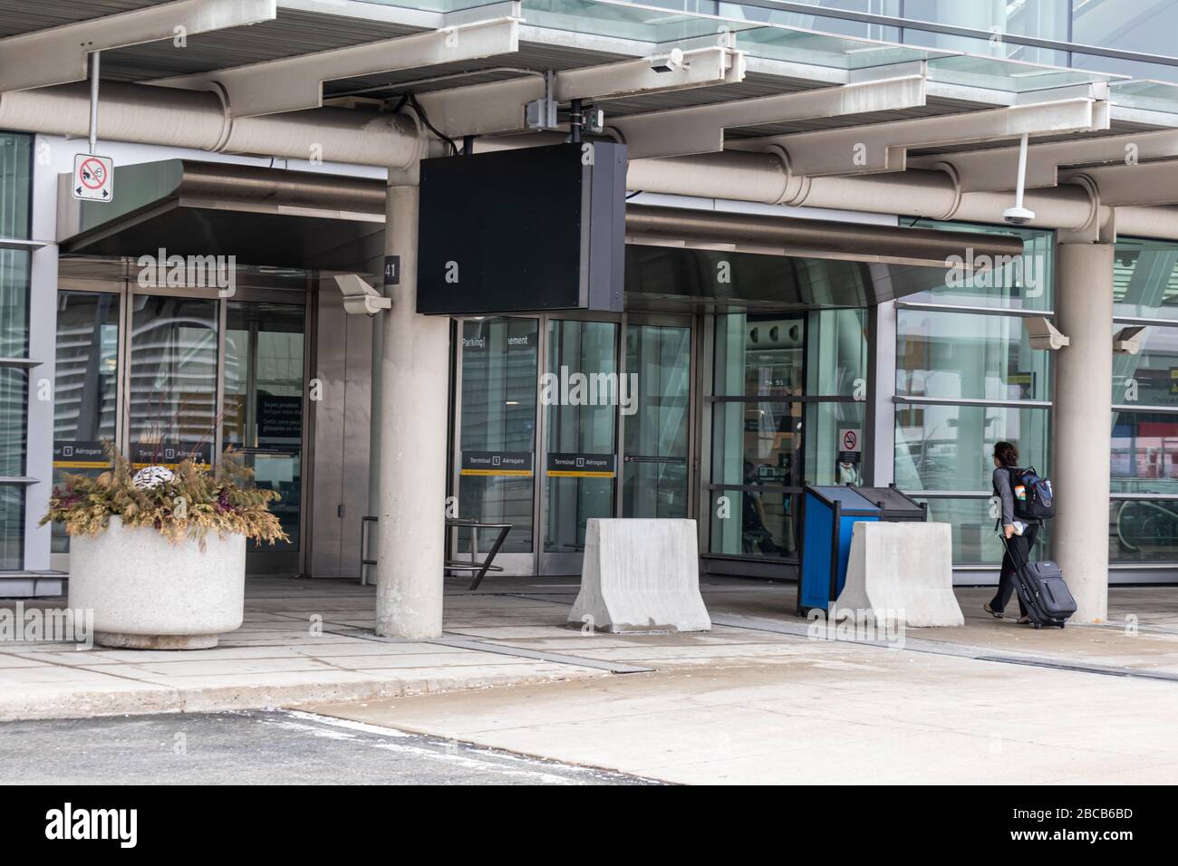 One person walk into Toronto Pearson's Terminal 1 main building as the airport is seen vacant due to the ongoing COVID-19 Pandemic. Stock Photo