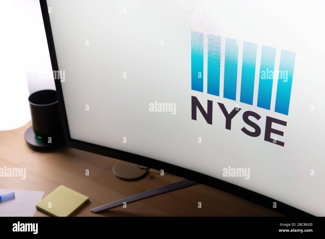 New York Stock Exchange (NYSE) logo displayed on a computer monitor on a desk. Stock Photo