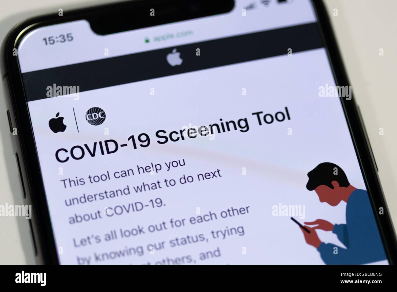 COVID-19 Screening Tool website by Apple and the CDC displayed on an iPhone. Stock Photo