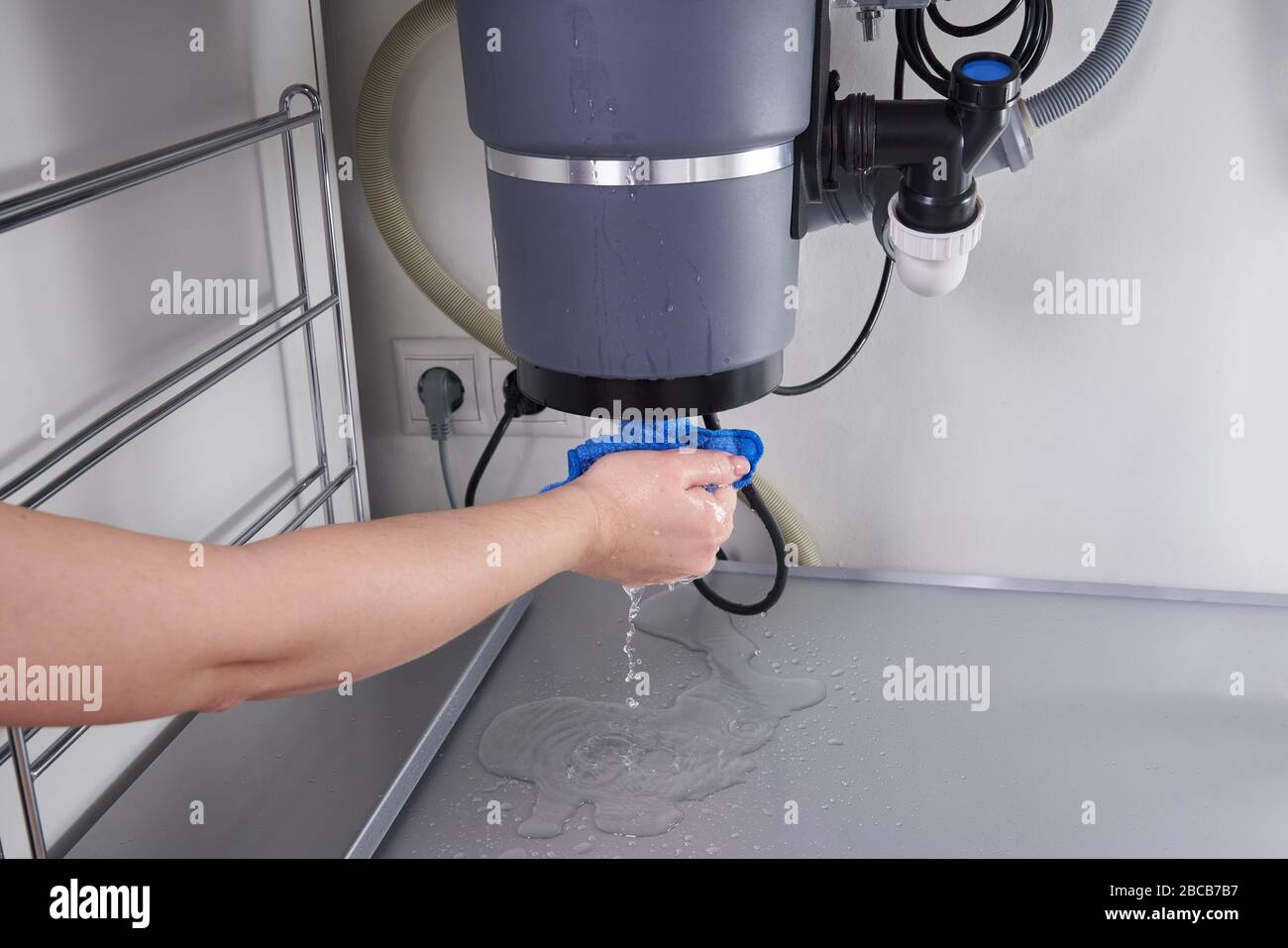 Waste disposal leak under a sink, broken garbage chopper Stock Photo Alamy
