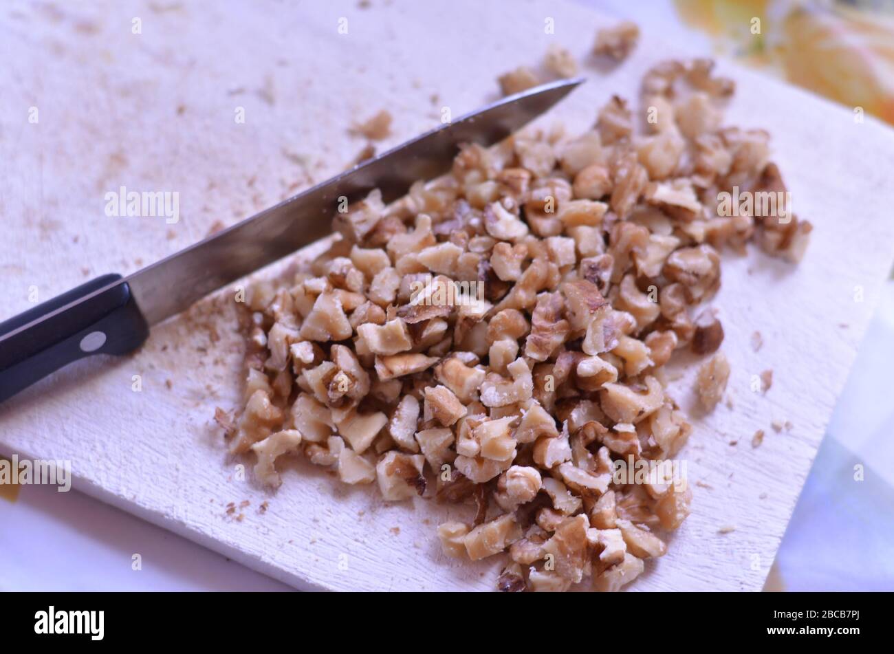 chopped walnuts on a chopping board Stock Photo Alamy