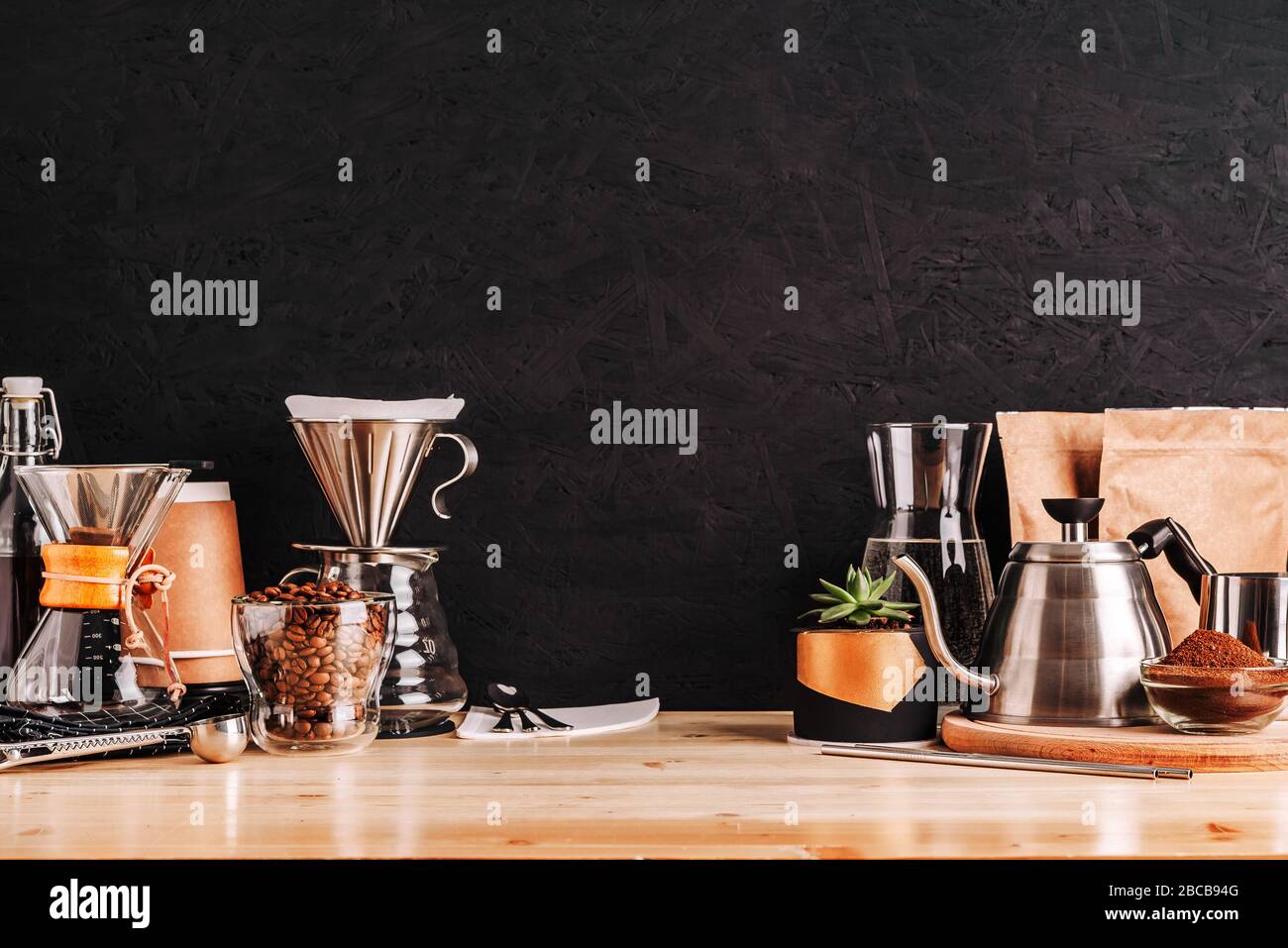 Accessories and utensils for making coffee drinks on a wooden table, coffee  shop interior Stock Photo - Alamy