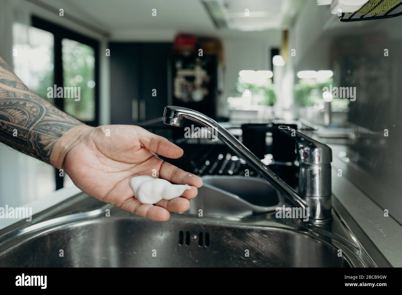 A man washing his hands with foam hand wahs for corona virus prevention, hygiene to stop spreading coronavirus. Stock Photo