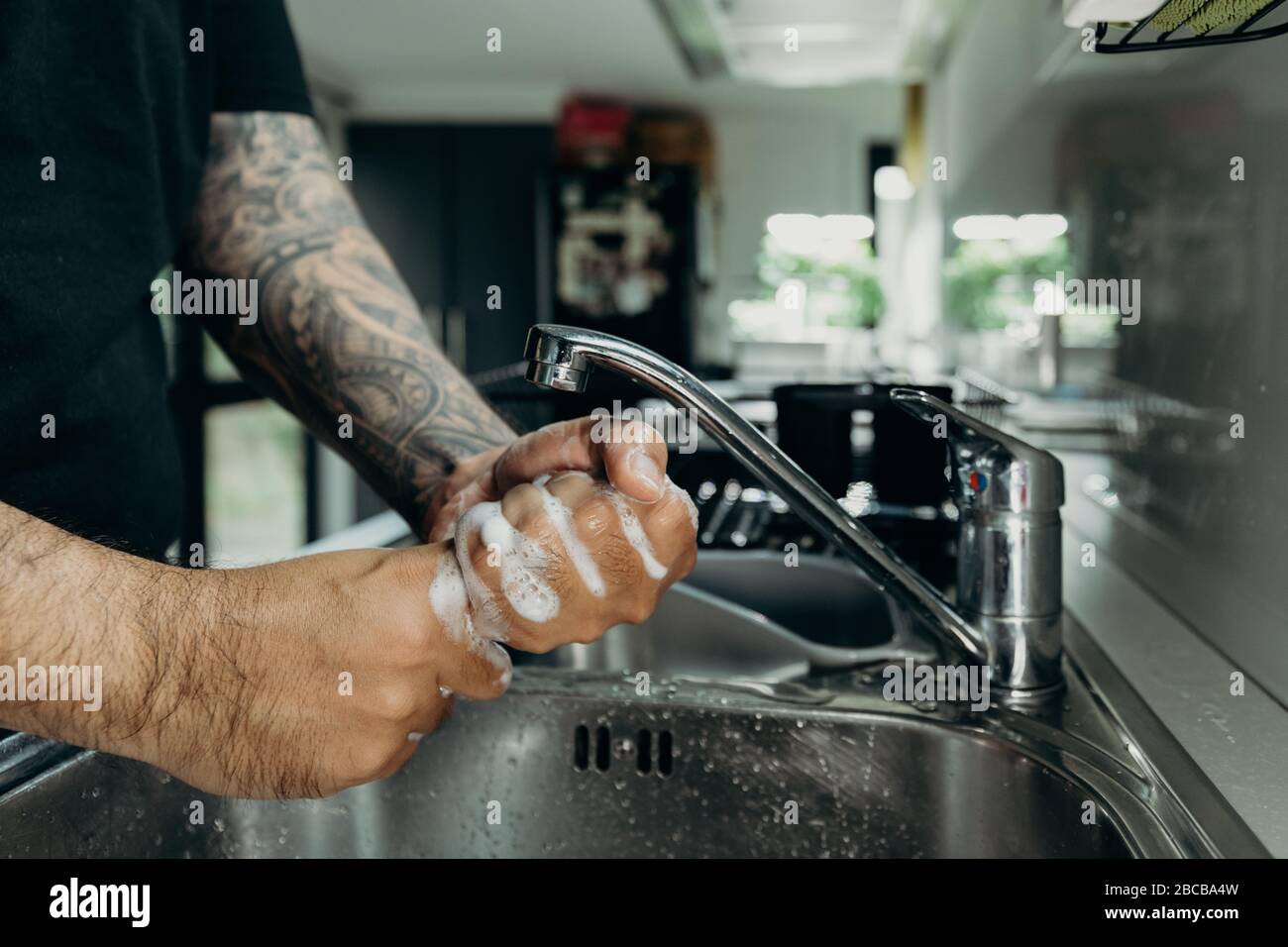 A man washing his hands with foam hand wahs for corona virus prevention, hygiene to stop spreading coronavirus. Stock Photo