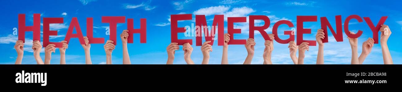 People Hands Holding Word Health Emergency, Blue Sky Stock Photo