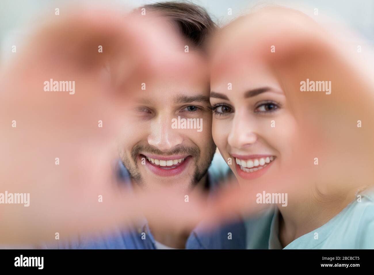 Young couple hugging at home Stock Photo