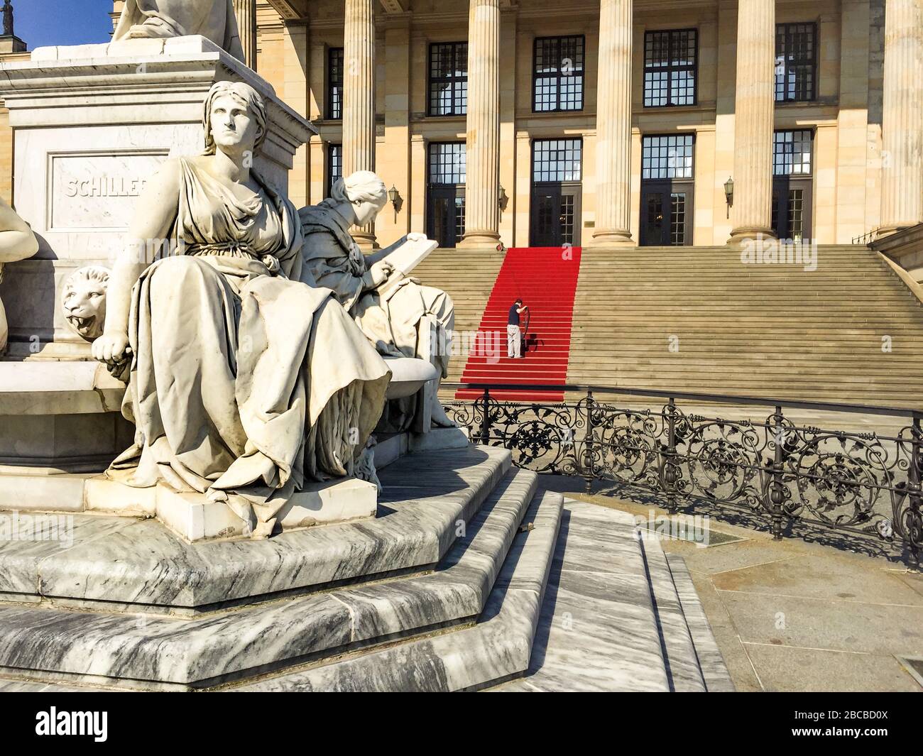 Worker cleaning the red carpet before the Konzerthaus in Berlin, German