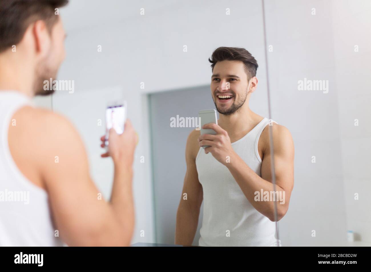 Man taking selfie in bathroom Stock Photo - Alamy