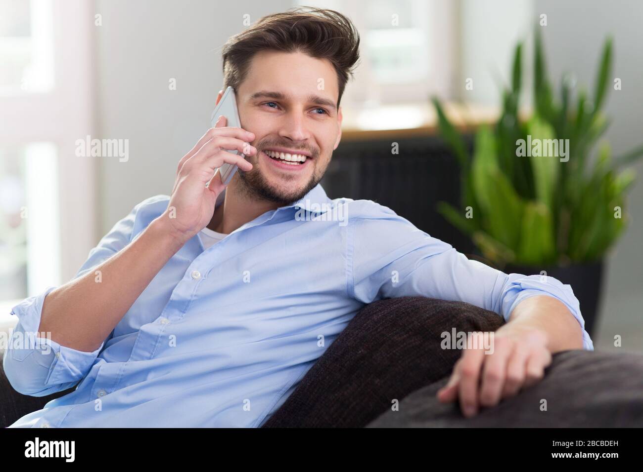 Young man relaxing at home Stock Photo