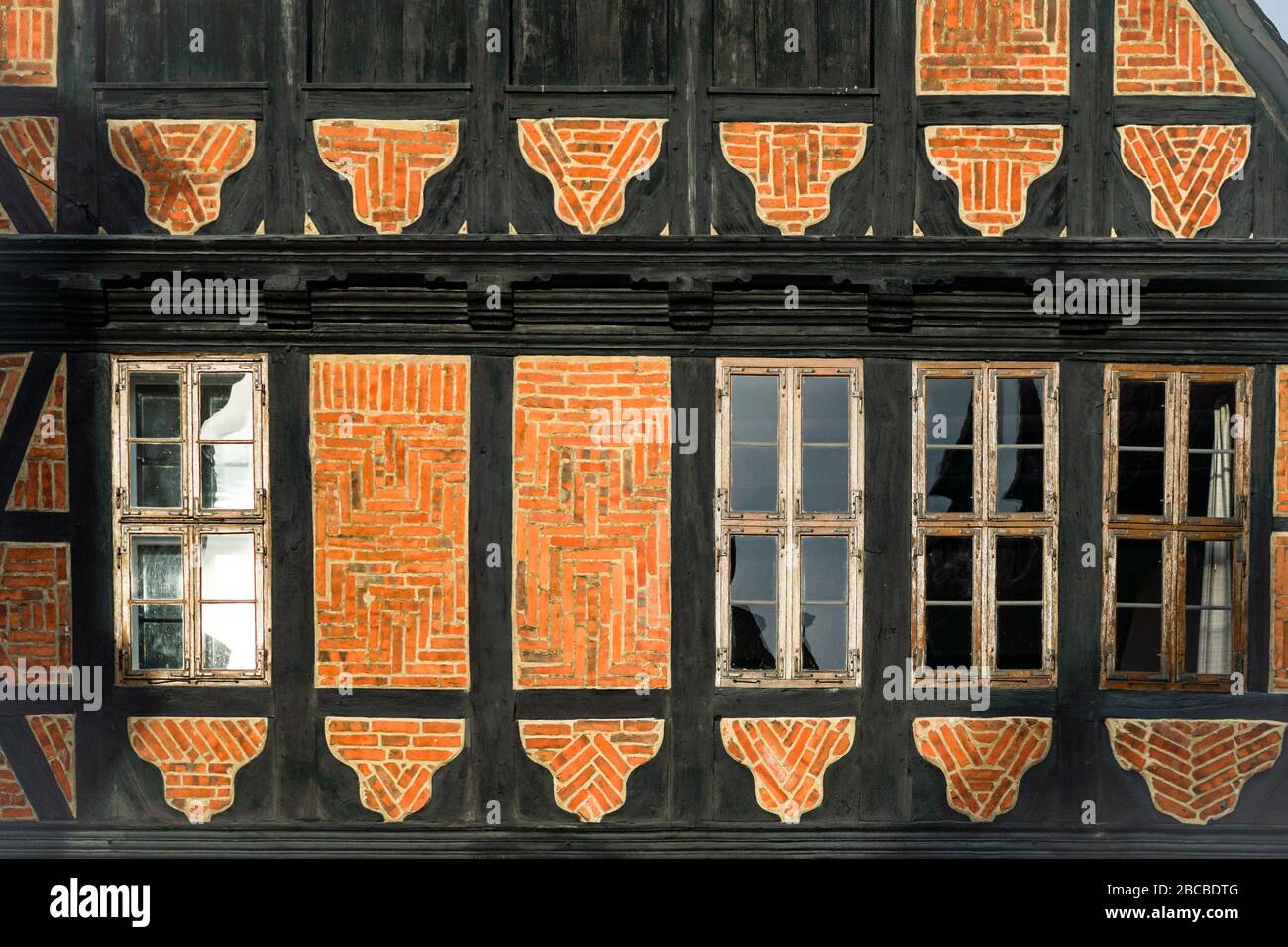 Facade of a half-timbered building with wooden framework, brick and old windows in UNESCO World Heritage Site Goslar, Germany Stock Photo
