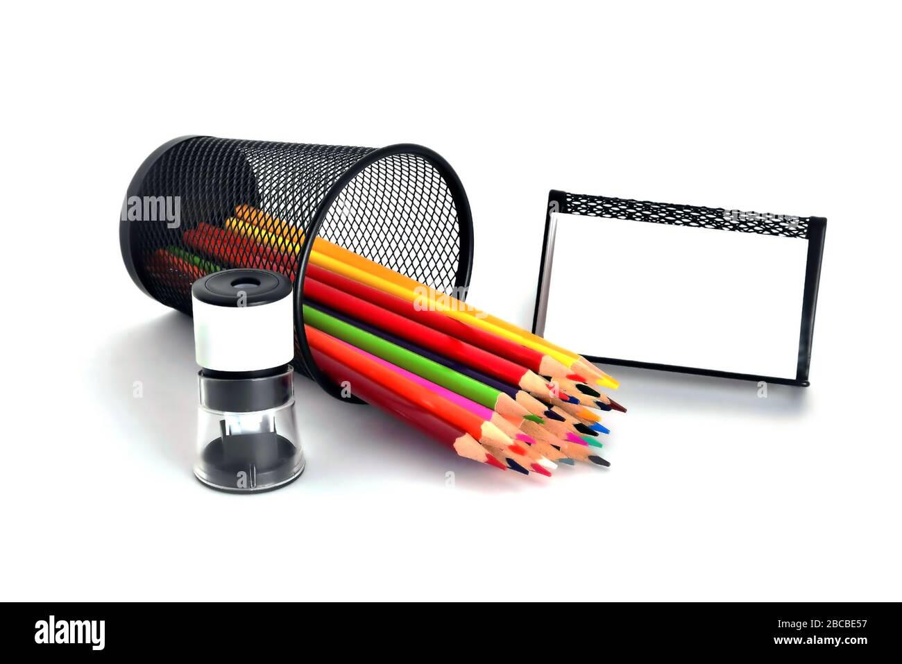 Color pencils, pencil sharpener, business card on white background Stock Photo