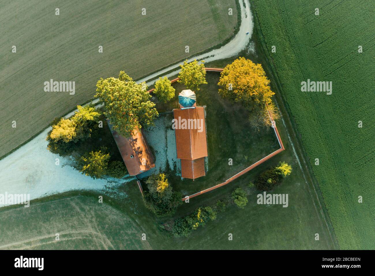 Aerial view of a small medieval country church in Bavaria in the autumn ...