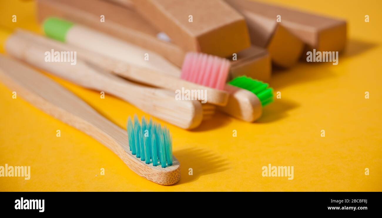 Eco bamboo kid colorful toothbrushes on the yellow background Stock ...