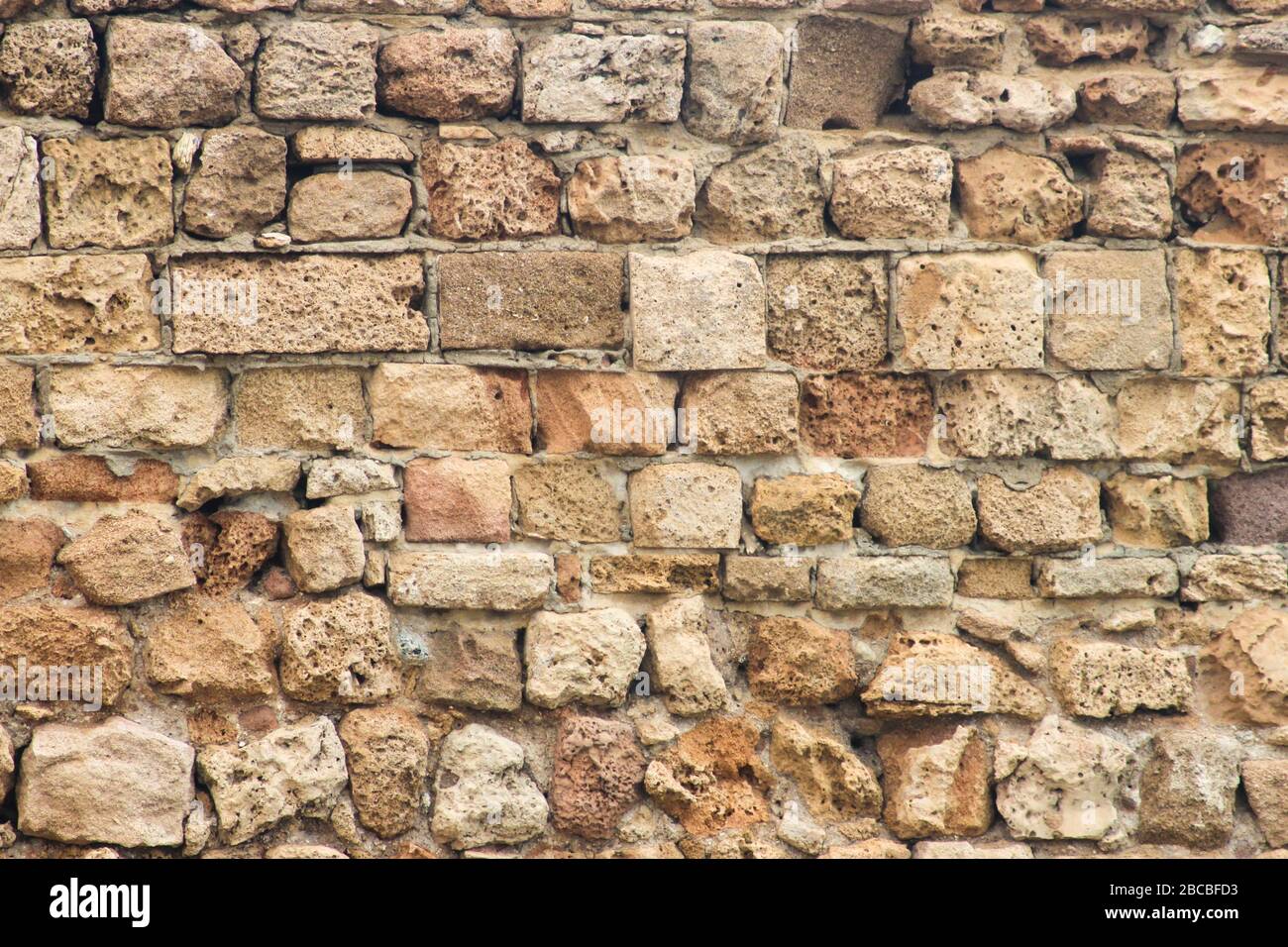 Ancient collapsing brick wall close up as background Stock Photo