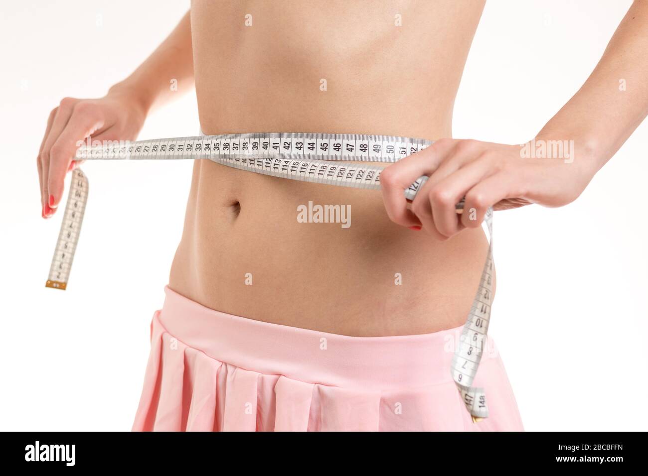 Woman measuring waist with tape in gym · Free Stock Photo